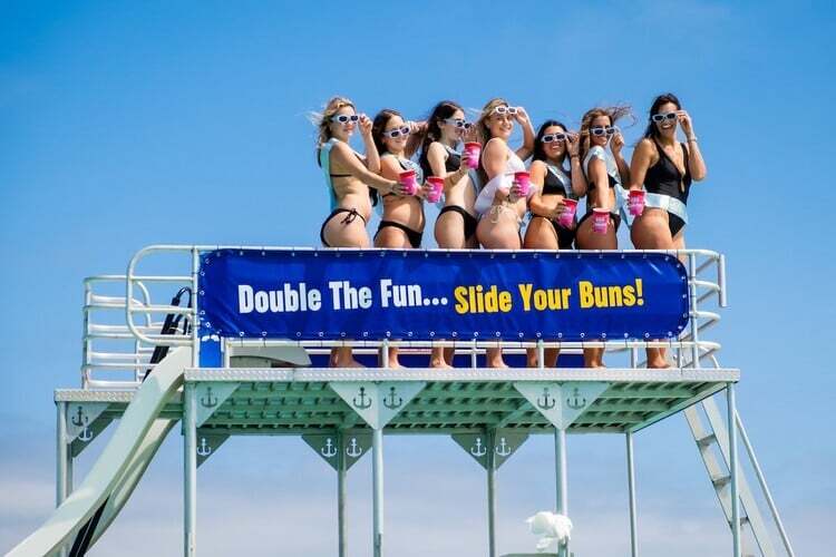 bachelorette party posing on second deck of double decker pontoon boat in destin