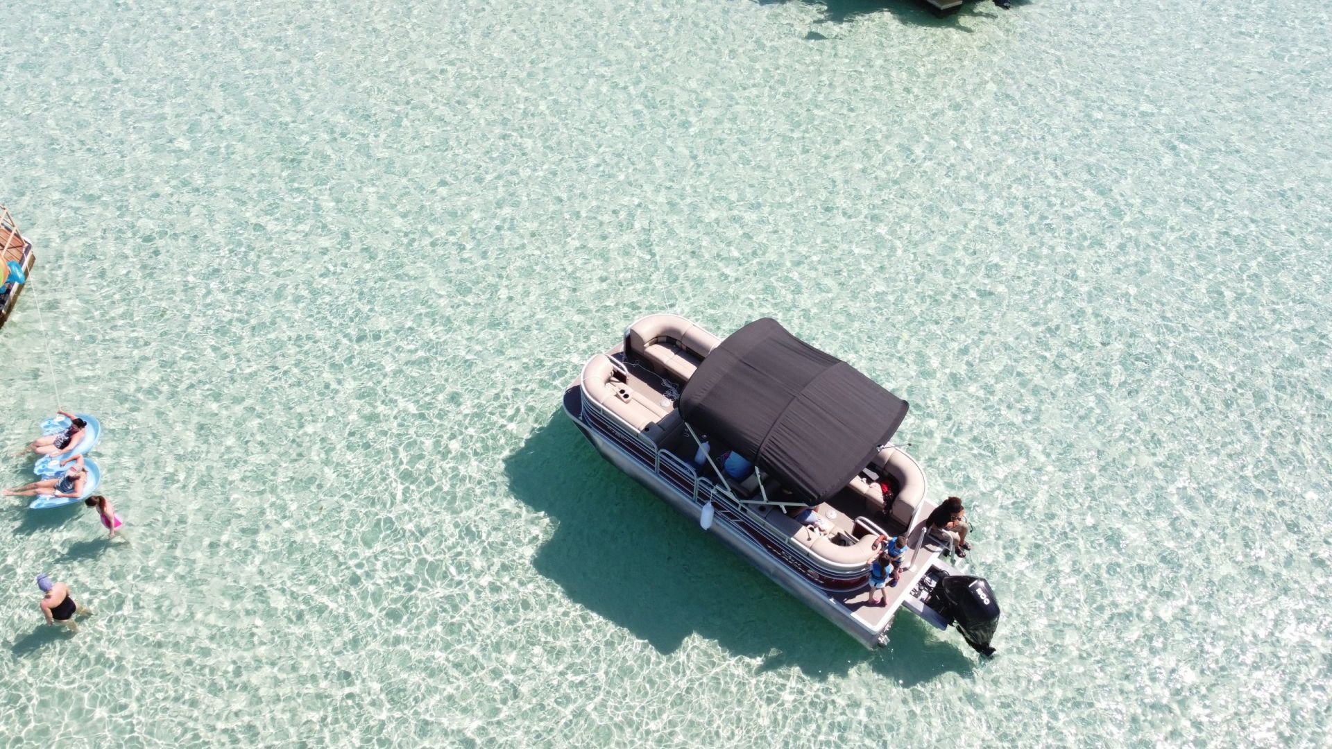 aerial view of luxury pontoon boat in water at destin, florida