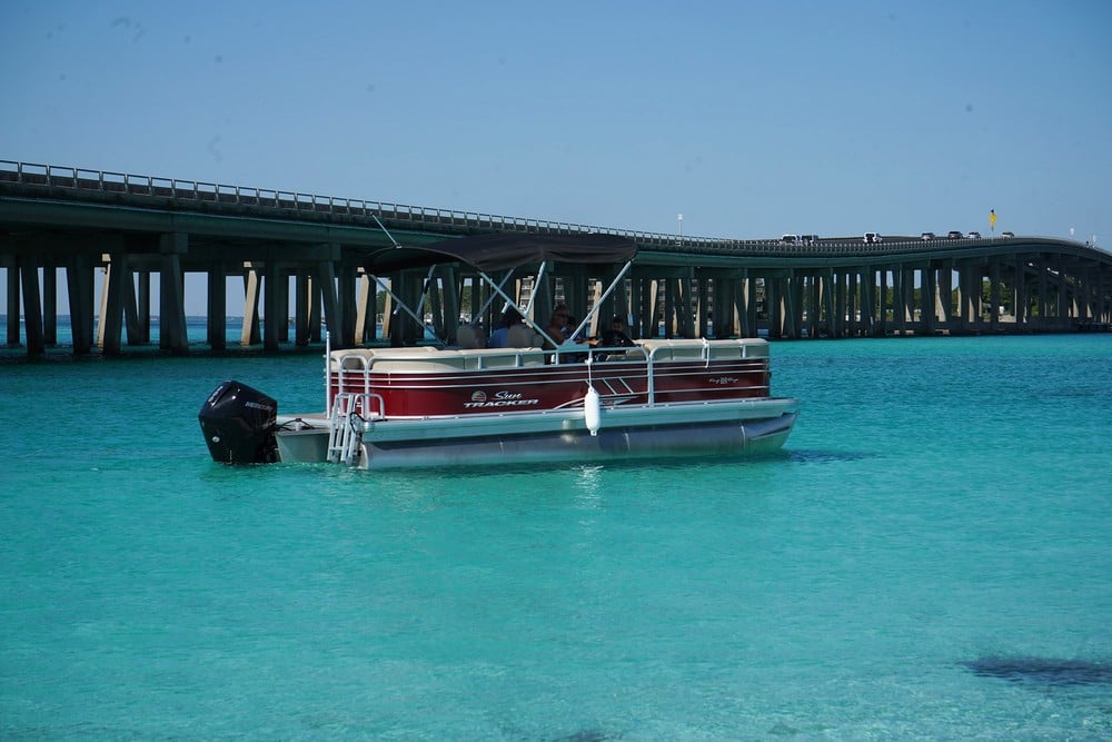 red pontoon boat in beautiful blue water at crab island