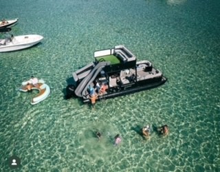 pontoon boat with waterslide anchored at crab island