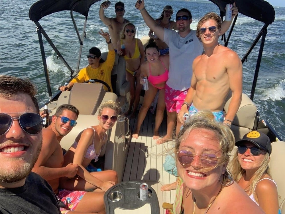 happy group of friends on pontoon boat in destin florida