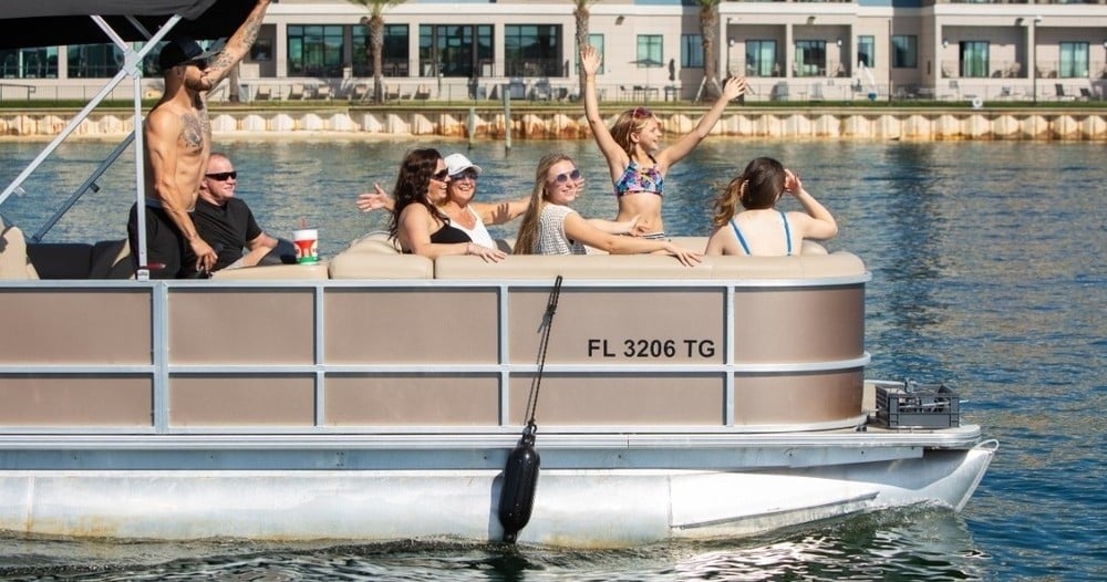 family riding pontoon boat in destin florida