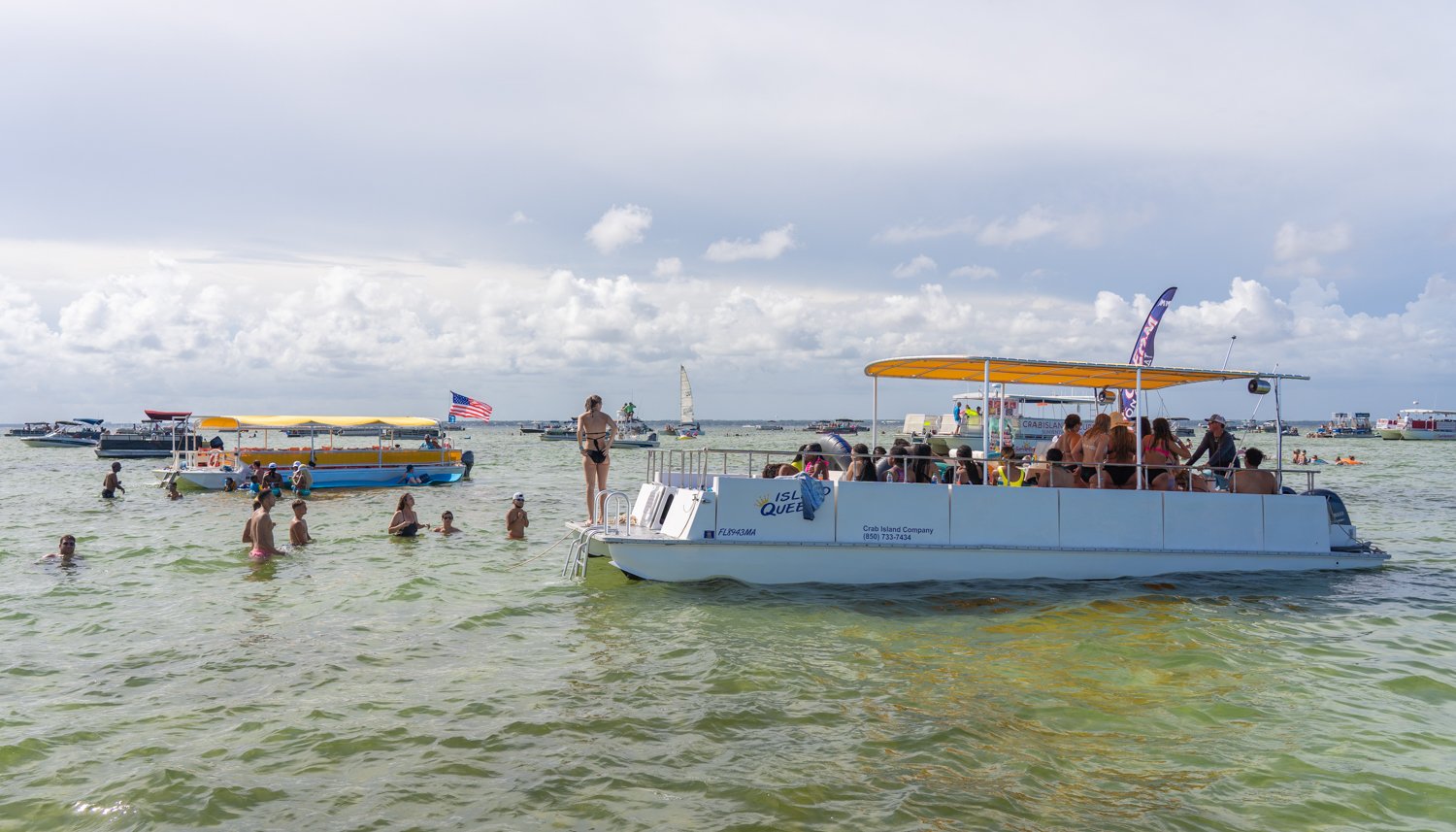 multiple people on a boat being shuttled to crab island
