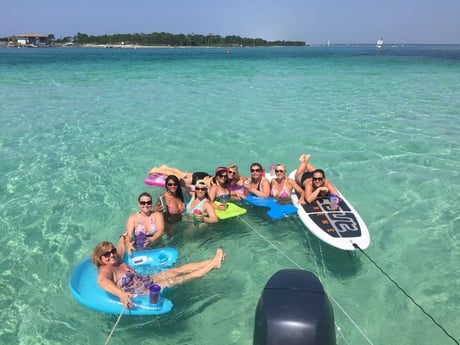 family relaxing at crab island behind the crab island shuttle boat