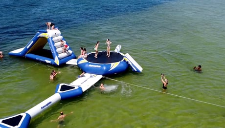 kids playing on a floating water park in destin, florida