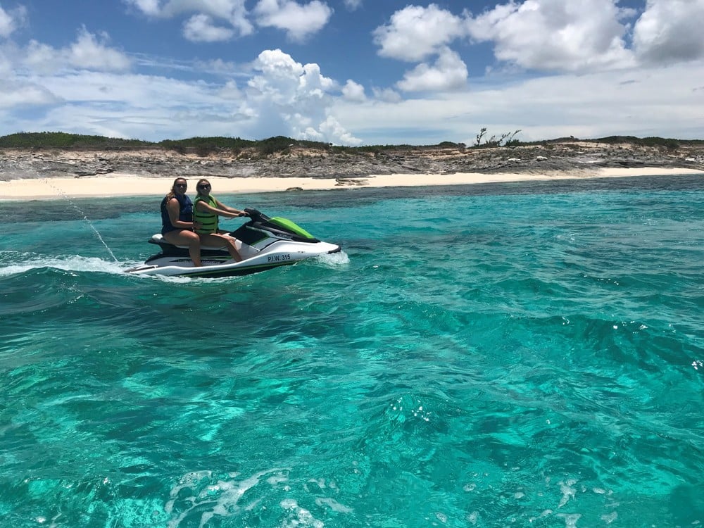 two people driving a jet ski to crab island
