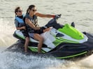 two ladies driving a green jet ski in destin florida 