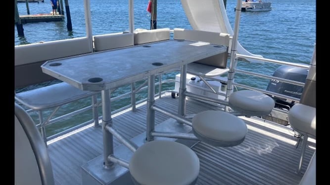 seating on a double decker pontoon boat with two slides in water in destin florida