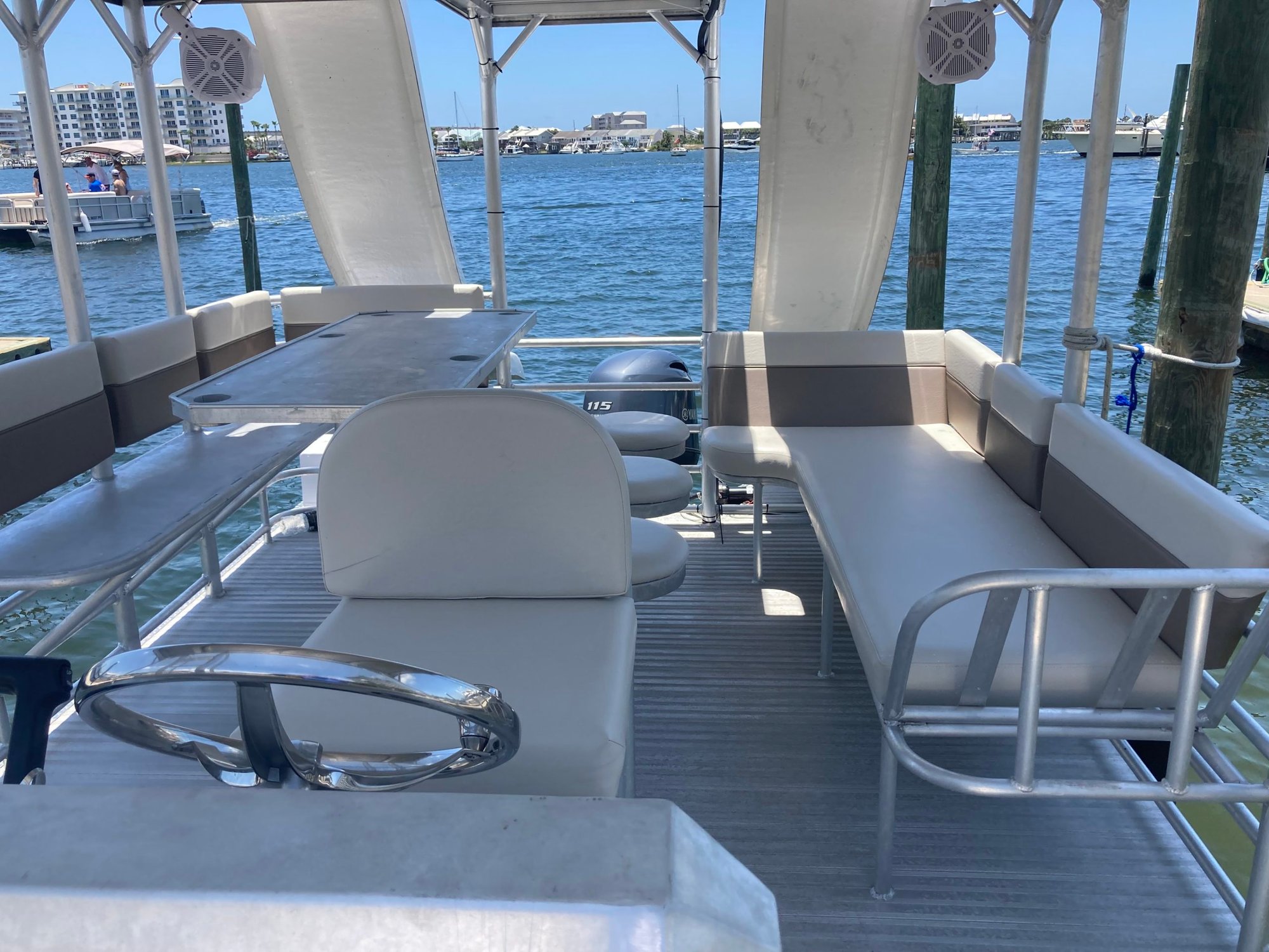 steering and slides on a double decker pontoon boat in the water