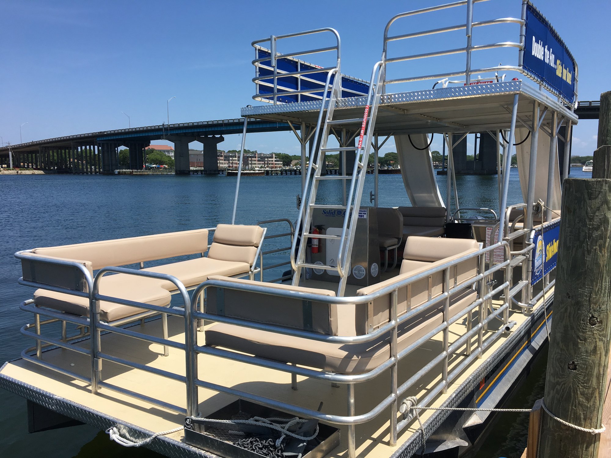 empty double decker pontoon boat with two slides in water in destin florida