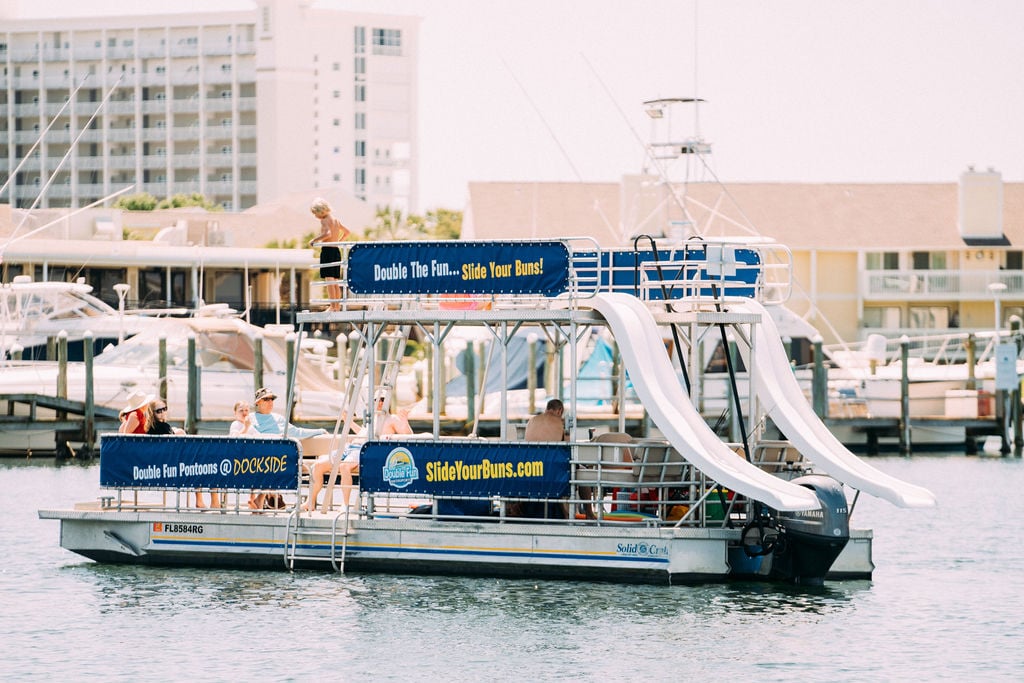 double decker pontoon boat with two slides in water in destin florida