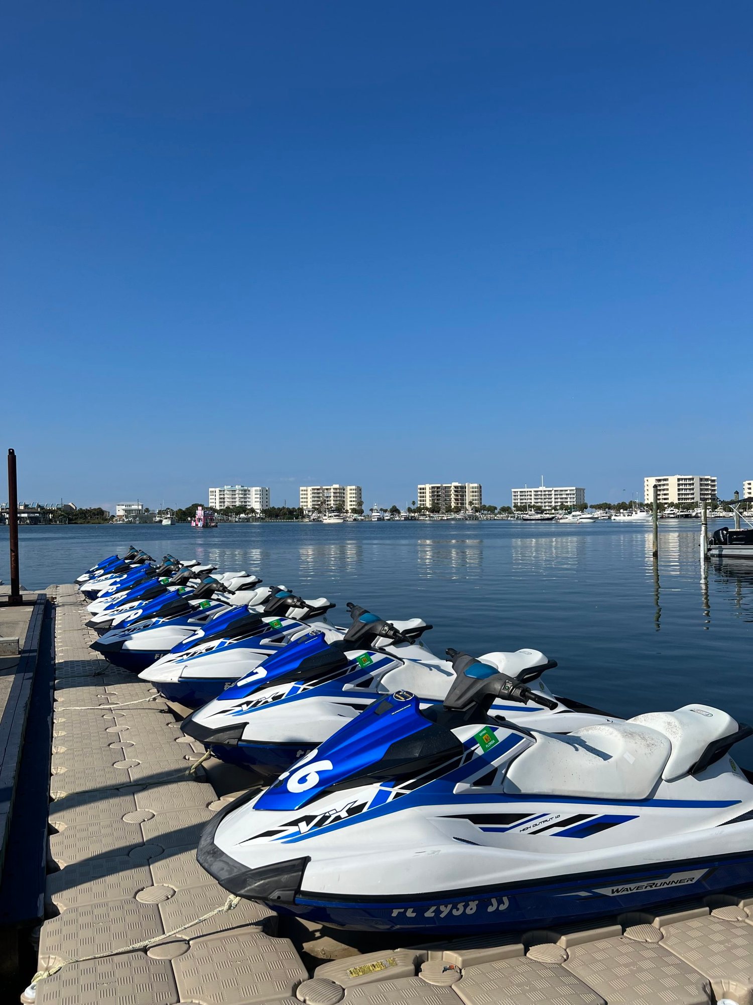 six jet skis lined up in the water in destin, florida