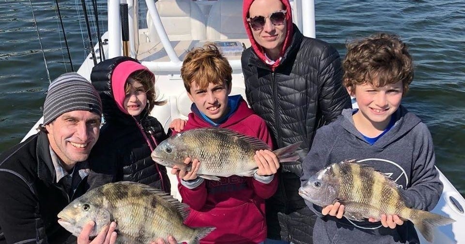 kids catching fish on a fishing charter trip in destin