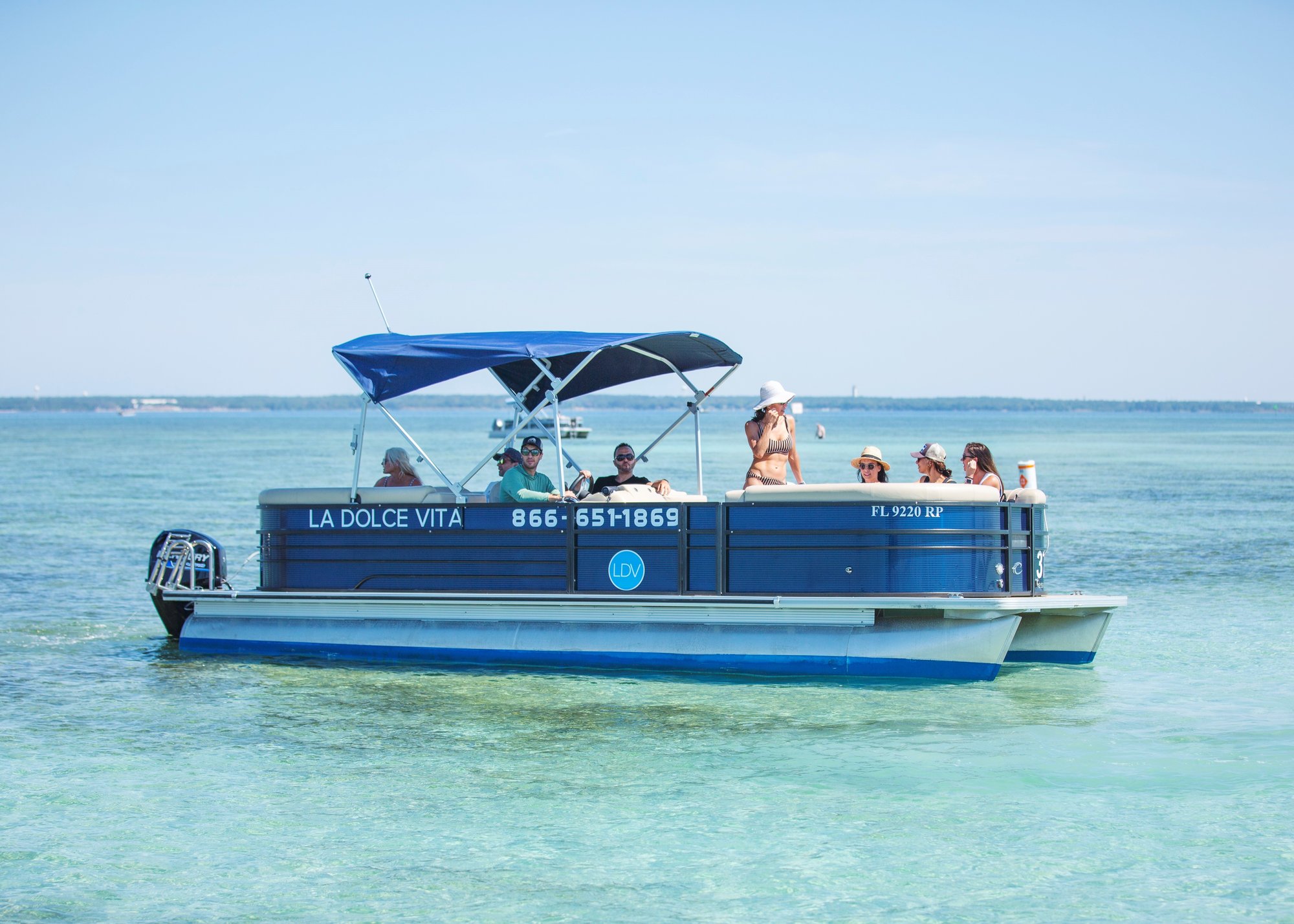 family on a blue pontoon in water in destin florida