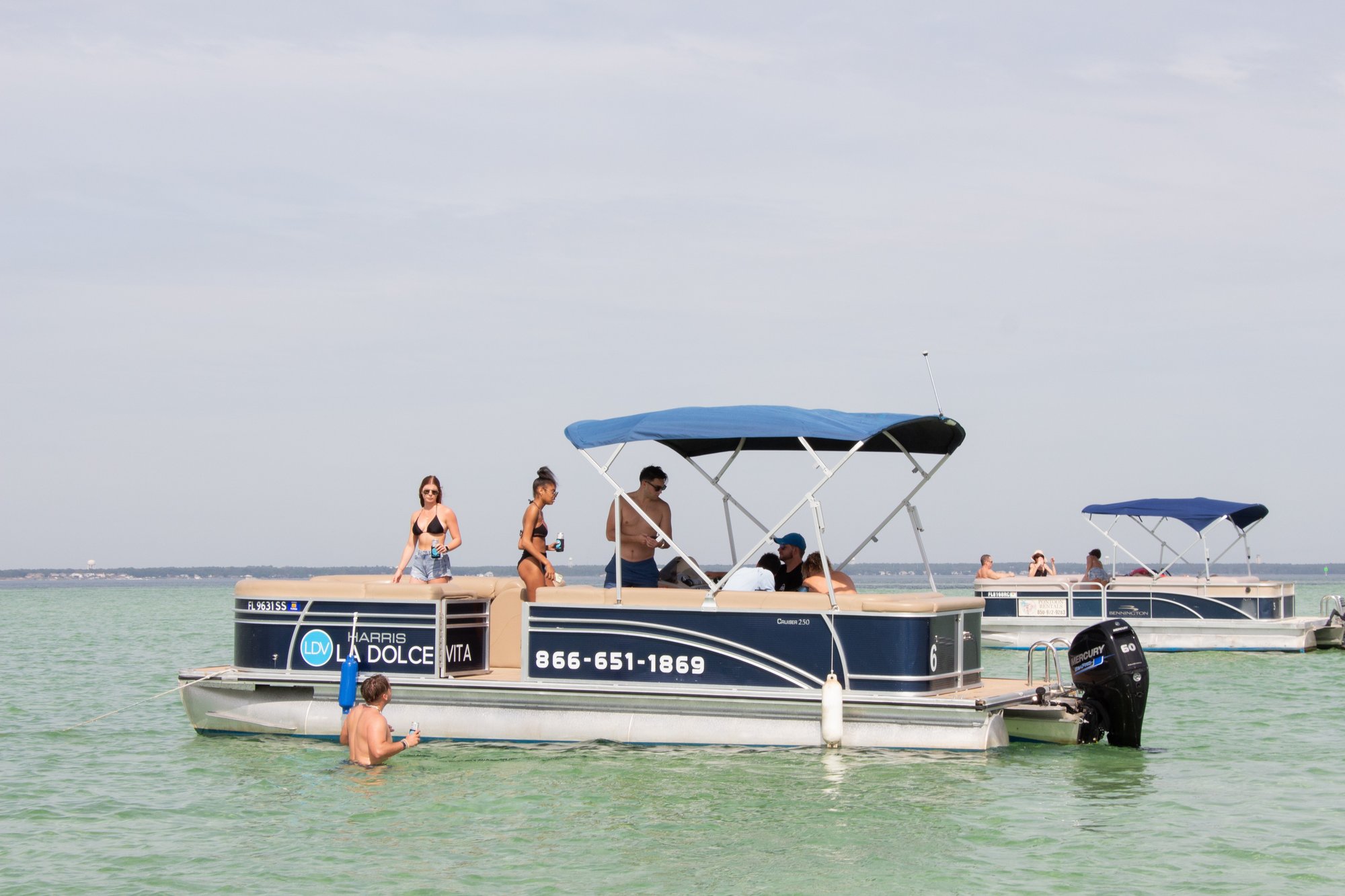 family on a pontoon swimming in water at crab island