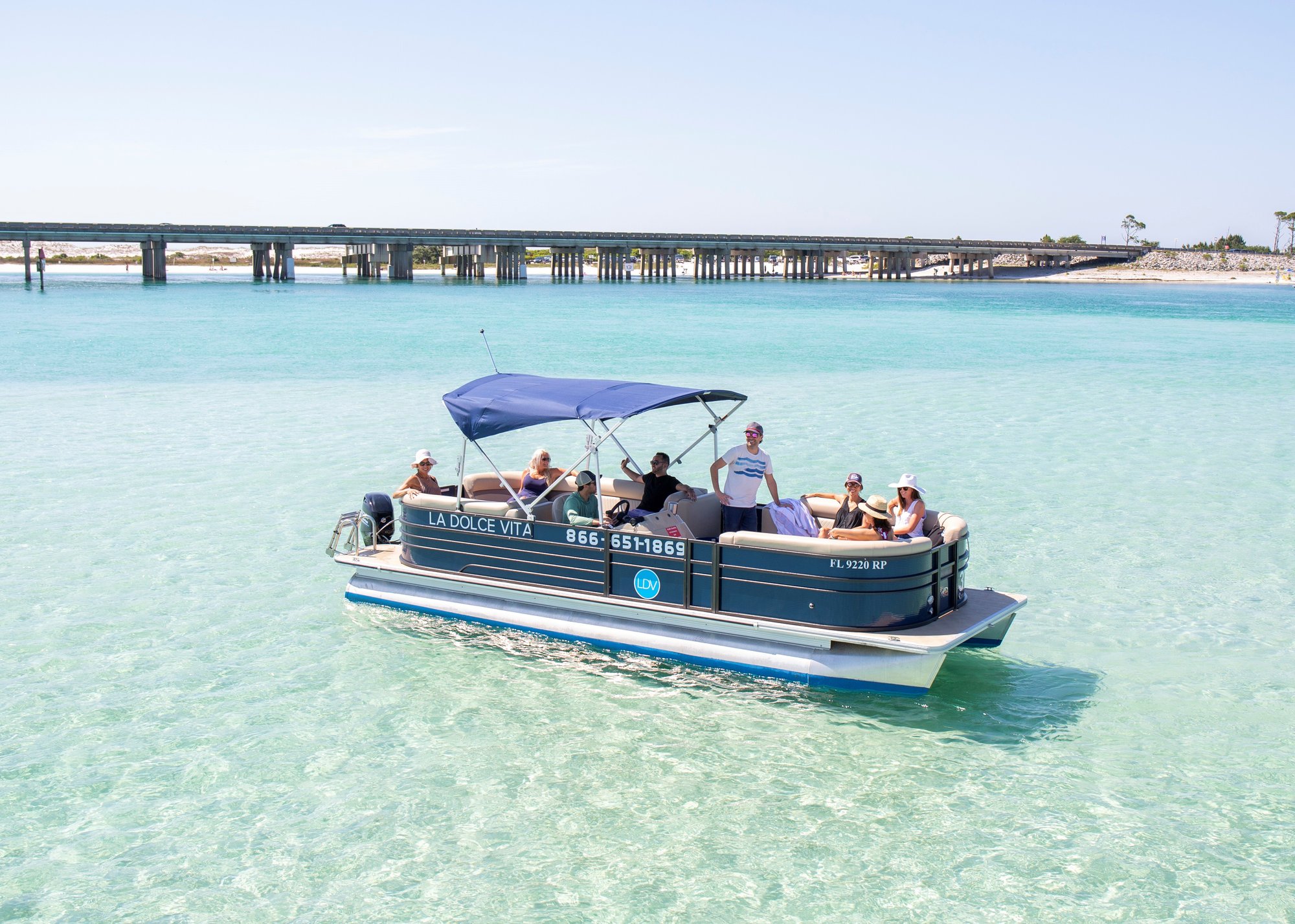 family exploring crab island on a pontoon boat with bimini