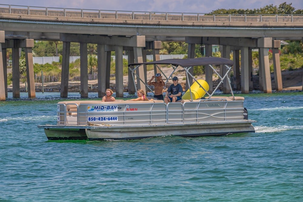 pontoon boat riding in the water in destin florida