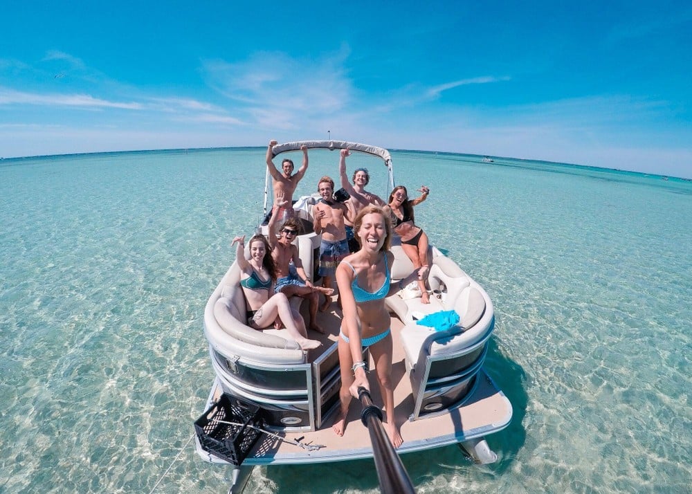 people having fun on a pontoon boat at okaloosa island