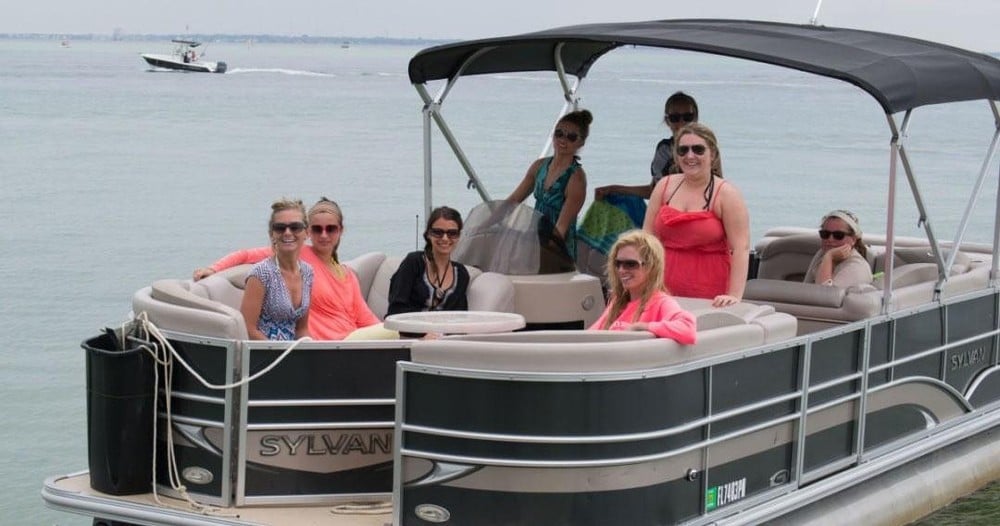 group of people having fun on pontoon boat at okaloosa island