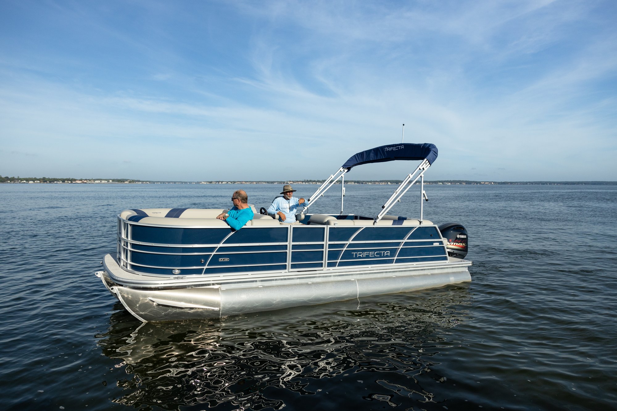 two people cruising on a pontoon boat in destin florida