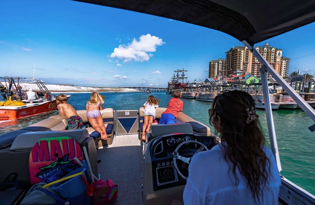 family cruising on a boat in the destin harbor