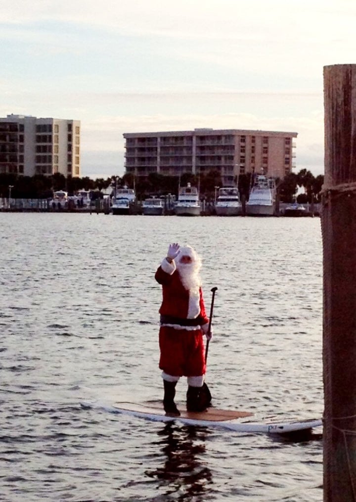 Santa paddle boarding in the Destin Harbor