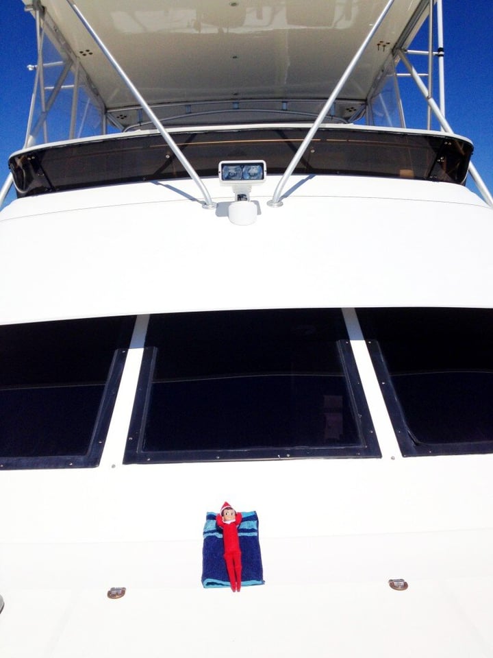 sunbathing elf on the front of a yacht