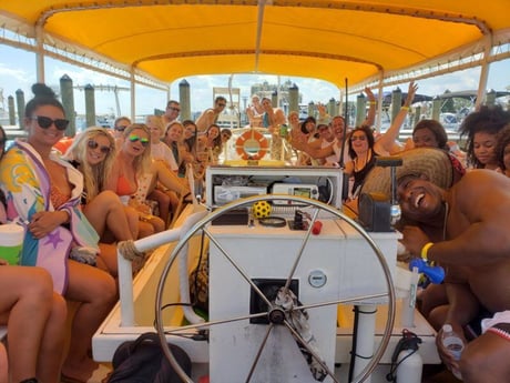 group of people smiling on a crab island shuttle boat