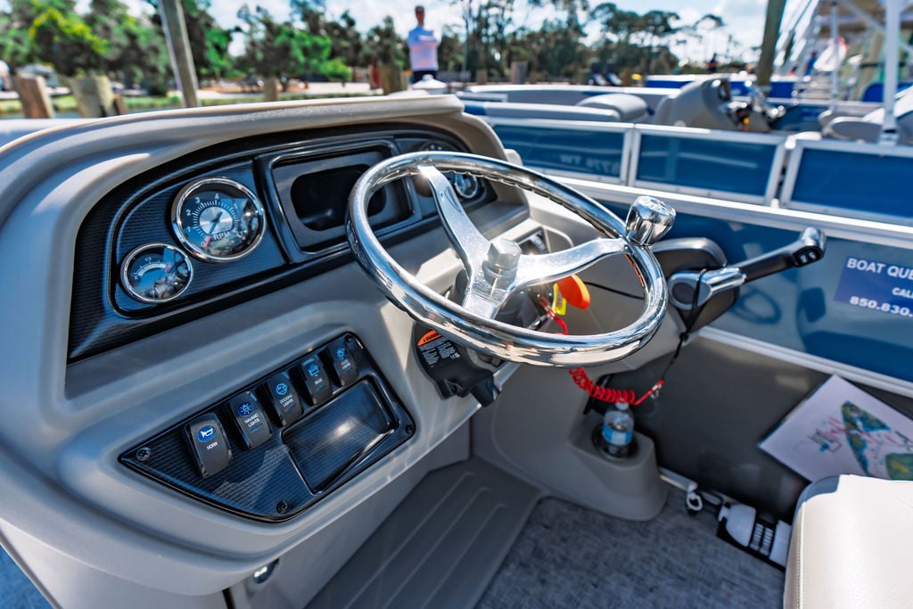 the steering wheel and helm on a pontoon boat