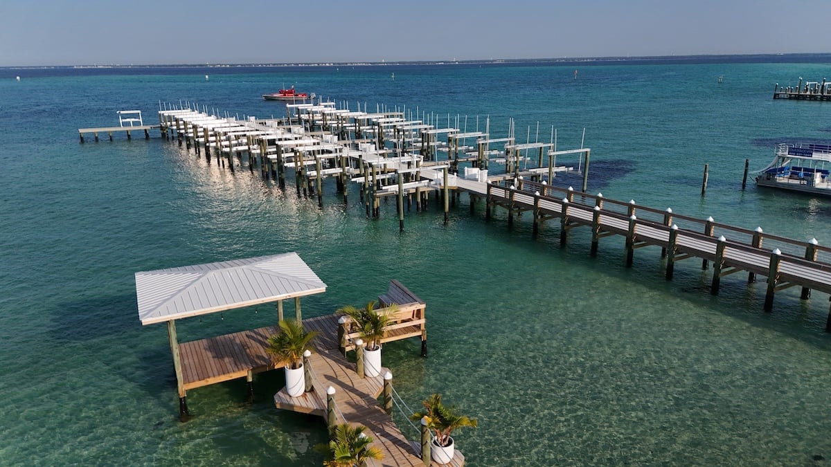 large dock with boat slips and small dock with bench in destin